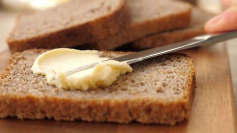 Spreading Vegan Butter On Rye Bread Without Dairy And Eggs. Closeup.