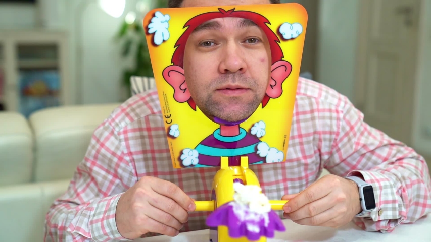 man plays in a fun and funny game pie in the face at home