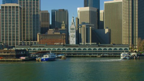 Aerial view of the San Francisco Ferry building with its famous clock tower. Market street and several skyscrapers in the background. Financial District. Shot on Red weapon 8K. California, US.
