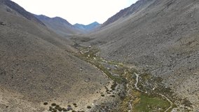 Aerial view Hydro Energy Power Plant inside Andes mountains at Atacama Desert extreme south. Capturing water at an arid climate in the top of the Andes green valleys. An awesome scenery at Andes heart
