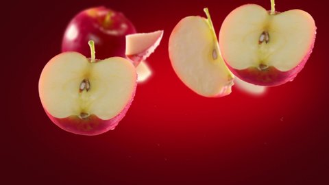 Flying of Red Apple and Slices in Deep Red Background