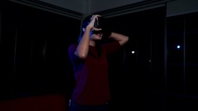 4K Young beautiful Asian woman teenager using virtual reality headset for playing video game. Young woman smiling and enjoying with high technology digital VR glasses for home entertainment at night.