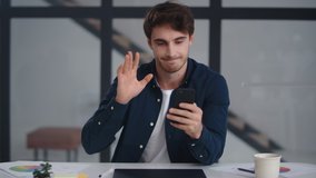Business man having video call on smartphone in slow motion. Close up serious guy making video chat online on mobile phone at home office. Focused businessman waving hands after conference call. - Powered by Shutterstock - Get 15% off with code: PIKWIZARD15