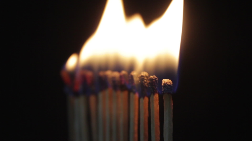 Line of burning matches contagion, match igniting in domino effect. line of light matches on black ground | Shutterstock HD Video #1048234924