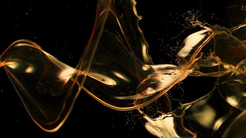 Super Slow Motion Shot of Swirling and Splashing Golden Oil Isolated on Black Background at 1000fps.