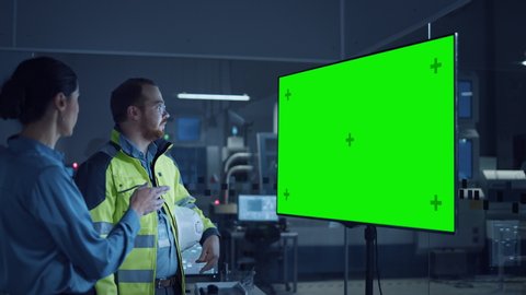 Office Meeting: Confident Female Project Manager to Chief Engineer, Watching Interactive Digital Whiteboard TV that Shows Green Screen Chroma Key Display. Modern Factory. Slow Motion Gestures