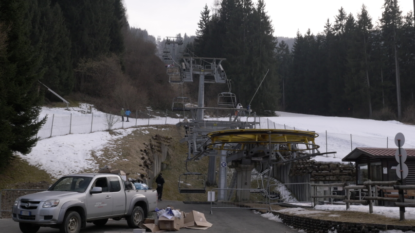 Ski Lift Working Low Side of Mountain. A ski lift is a mechanism for transporting skiers up and down a hill.