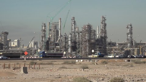 YANBU, SAUDI ARABIA – DECEMBER 2019: Traffic drives past oil refineries and industrial plants (partly under construction) in Yanbu, economy and petrochemical sector in Saudi Arabia
