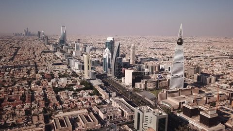 RIYADH, SAUDI ARABIA – DECEMBER 2019: Drone flight towards spectacular Riyadh skyline with modern office towers, located in the deserts of Saudi Arabia in the Middle East
