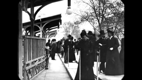 CIRCA 1880s - Parisian men and women board a moving sidewalk.