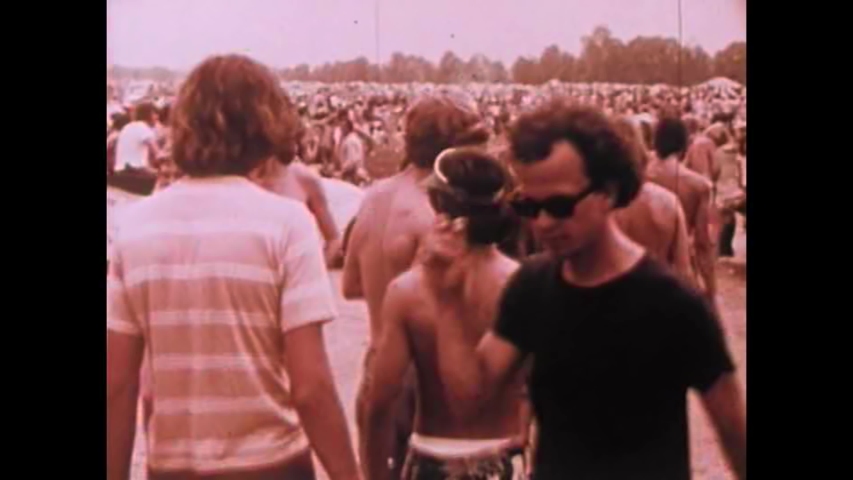 CIRCA 1960s - Hippies smoke dope marijuana and pot and do drugs at a rock concert in the 1970's.