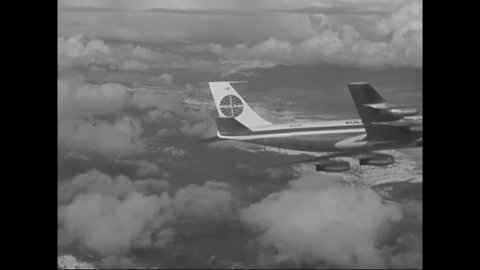 CIRCA 1950s - A Pan Am jet plane is seen in flight, air to air airplane.