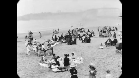 CIRCA 1900 - Families are seen on a beach in Biarritz, France.
