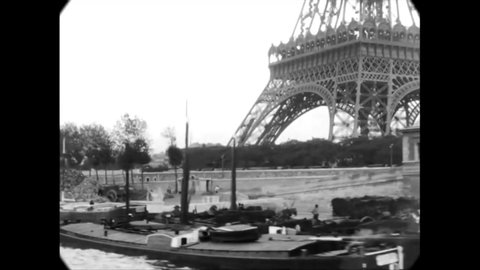 CIRCA 1880s - The Eiffel Tower is filmed from a boat sailing down the Seine in Paris, France.