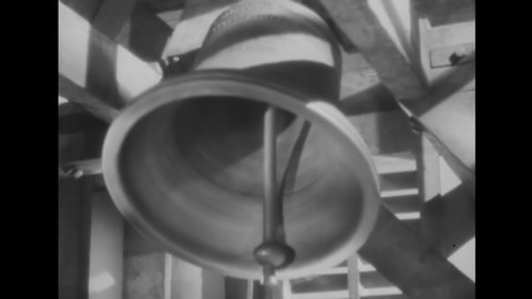CIRCA 1938 - A close-up shows a large bell being rung in a tower suggesting freedom, religion, liberty or patriotic americana.