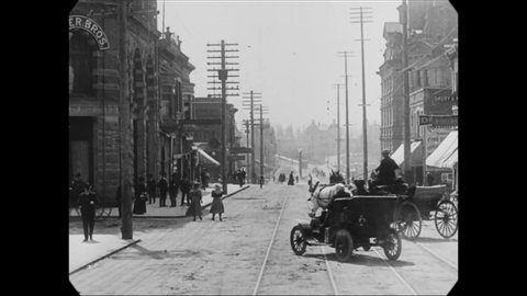 CIRCA 1907 - A camera fixed to the front of a trolley in Vancouver, Canada captures footage of vehicular and foot traffic.