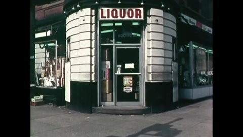 CIRCA 1974 - A criminal flees a liquor store robbery and an African American policeman corners him in an alley and points his pistol, in Alexandria.