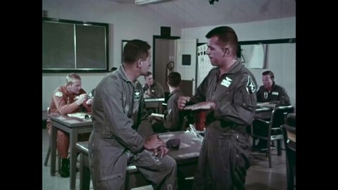 CIRCA 1966 - Airmen converse argumentatively about procedures at a military supersonic jet school.