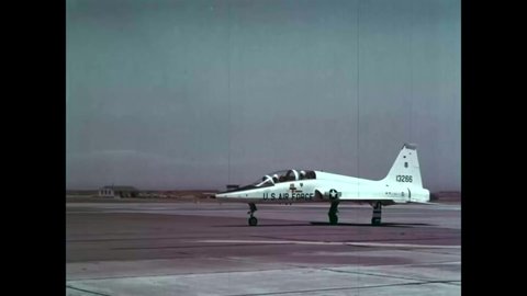 CIRCA 1966 - A student airman flies a Northrop T-38 Talon aircraft away from Hamilton Air Force base, in California, with his flight instructor.