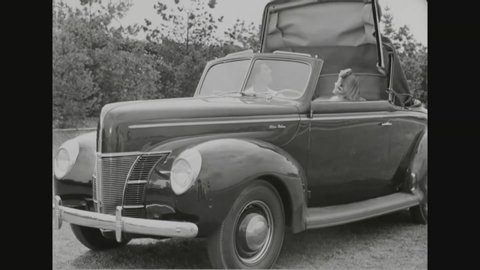 CIRCA 1942 - A compartment for suitcases is shown in the Ford deluxe business coupe and a vacuum-operated automatic top.