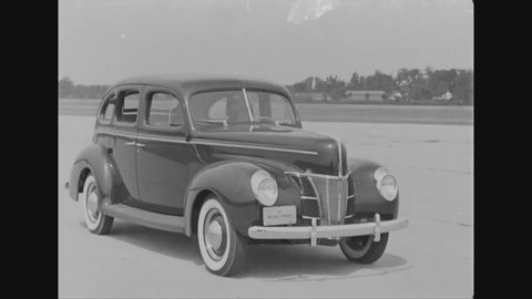CIRCA 1942 - Four-door and two-door Ford sedans are driven as well as the Ford deluxe business coupe and the Ford convertible club coupe motorcar.