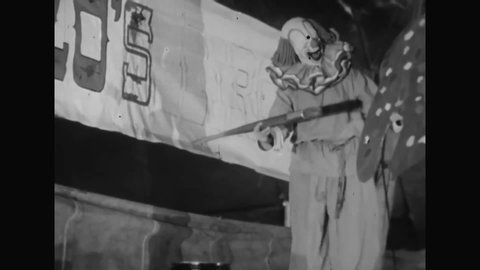 CIRCA 1951 - Bozo the Clown paints a banner, knocking some paint on to a clown cop, who he tries to clean with a mop.