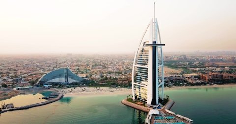 Dubai, United Arab Emirates - March 8, 2020: Dubai seaside skyline and Burj Al Arab luxury hotel aerial view at sunrise in the UAE