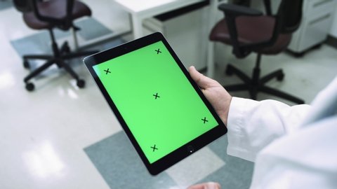 MOTION TRACKING an ipad in a scientific lab walking around looking at data