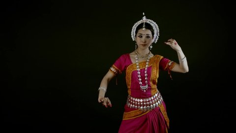 Odissi female asian dancer perform, Indian traditional, 4k studio shot on black backdrop 