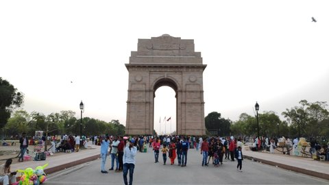 New Delhi, India - March 13, 2020: tourist visitors at india gate, crowd walking on india gate road, most visited place at delhi, picnic spot  