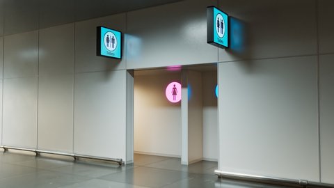 Toilets entrance. Man and woman section. Pink and blue. WC sign. Public place like airport terminal, hospital, bus or train station and any other type. Clean. Heading camera. Indoor. Corridor
