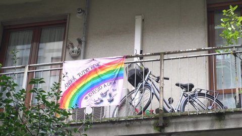 Europe, Italy, Milan March 2020, Coronavirus emergency - On the windows of the city balcony hang sheets designed by children with rainbow and the words "everything will be fine" ( Tutto Andra' bene )
