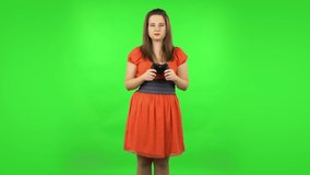 Cute girl playing a video game using a wireless controller with joy and rejoicing in victory. Green screen