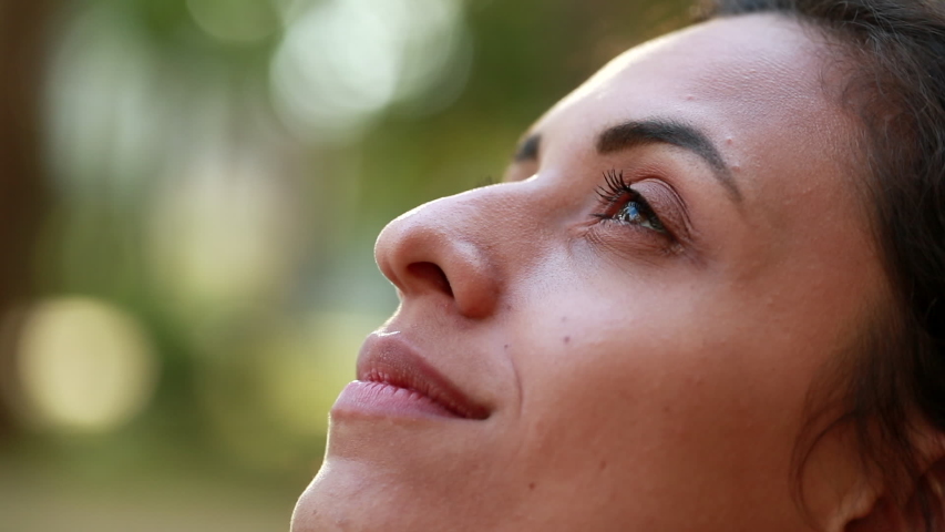 Woman looking up to the sky with hope and faith, contemplative close-up girl face Royalty-Free Stock Footage #1048330285