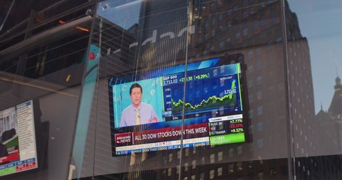 New York, New York / United States - March 13 2020: TV Monitors at the NASDAQ show news reports of stock market crash do to Coronavirus, COVID-19.