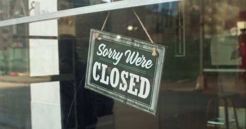 New York, New York / United States - March 13 2020: Coronavirus, COVID-19 causes the cancellation of all Broadway shows. Sorry we're CLOSED sign hangs in bar window in theater district. Tight shot.