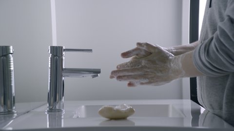 Locked shot of women washing hands throughly to avoid spread of Covid 19. Clean hygiene measures may help spread of infectious virus. Filmed in 10bit Pro Res 50fps. Set clip to 25fps for nice slo-mo.