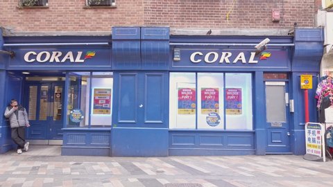 London / UK - February 22nd 2020  - Exterior of Coral bookmakers betting shop in Chinatown. Camera pans to the left. 