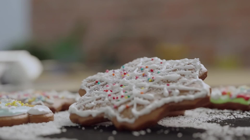 Star-shaped Christmas gingerbread with icing. Sprinkled with beautiful sugar sprinkles.