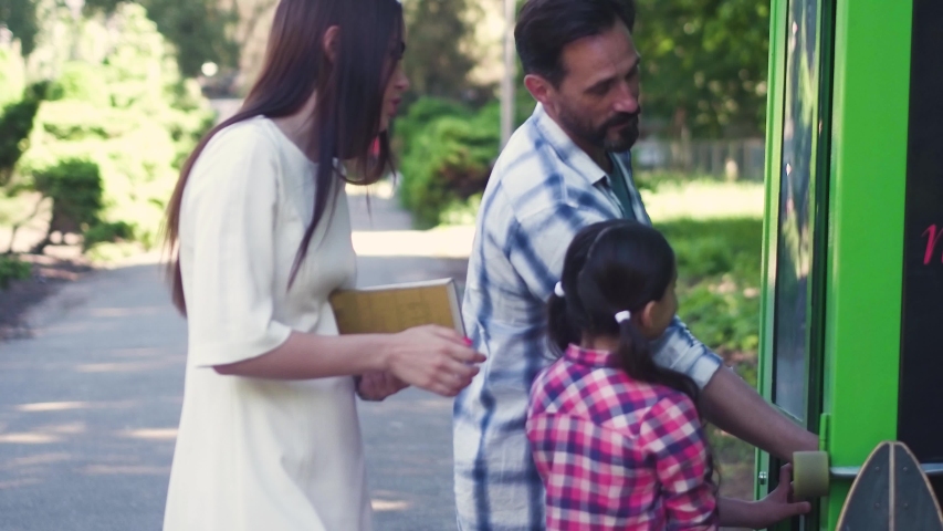 Happy Family Spending Time At Summer Park Or City Garden Buying Hot Or Cold Coffee Or Tea From Green Vending Machine