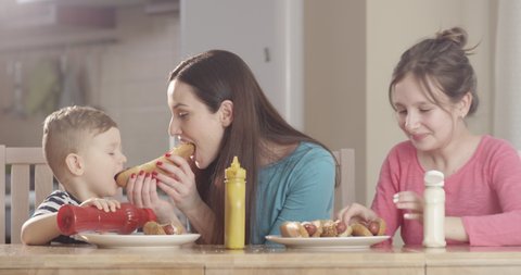 Family at the Kitchen Table Preparing Hotdogs and Enjoying Food Having Great Time Shot on Red Camera