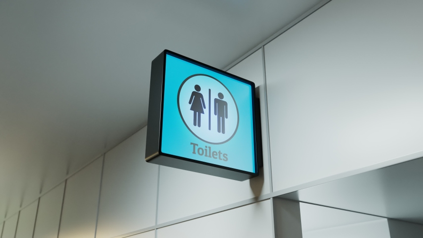 A camera is focuses on sign of toilets in public place like airport terminal, hospital, bus or train station and any other type. Blue background. Entrance. Sunny day. Indoor. Corridor. Guide. Access
 Royalty-Free Stock Footage #1048367632