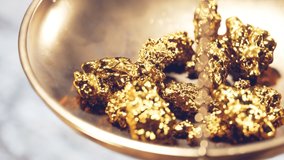 Close up of a jewelry scale dish with gold nuggets. Weighting gold ores on an old brass scale dish for trade or exchange. Concept of Wealth, treasure, fortune, success, luxury, money
 - Powered by Shutterstock - Get 15% off with code: PIKWIZARD15