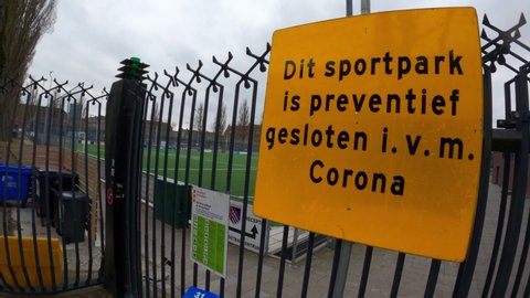 Amsterdam, the Netherlands, March 15, 2002. Closed gate at sports club with sign saying 'closed due to Corona'. 