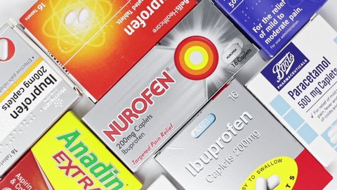 London / UK - March 15th 2020 - Boxes of branded pain relief medication slowly rotating,  paracetamol, anadin, ibuprofen and nurofen