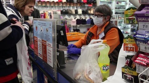 DNIPRO UKRAINE 03/14/2020 
An employee of a market store employee, cashier, works in a respirator mask. Quarantine Coronavirus