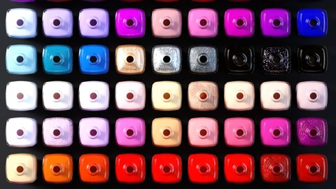 Seamless looping animation with many opened nail polish bottles arranged by shade. Top view of vibrant, beautiful, timeless fashion colors. Elegant glass bottles on the dark surface.
