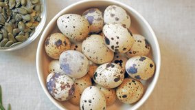 Quail eggs in a bowl on a table. eating organic food in the kitchen