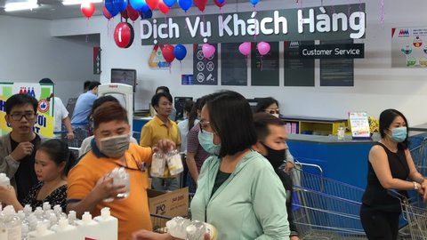 Ho Chi Minh City / Vietnam - 03 07 2020: Shoppers wearing face masks enter crowded supermarket during Coronavirus outbreak on March 7th, 2020 in Ho Chi Minh City, Vietnam in Asia.