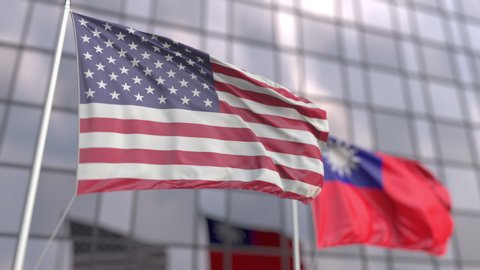 Waving flags of the United States and Taiwan in front of a modern skyscraper facade